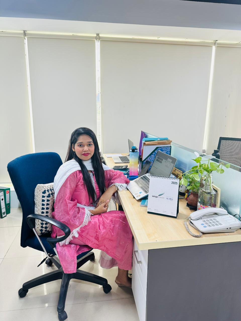 Halima Yesmin Mukta sitting on a chair at his workstation